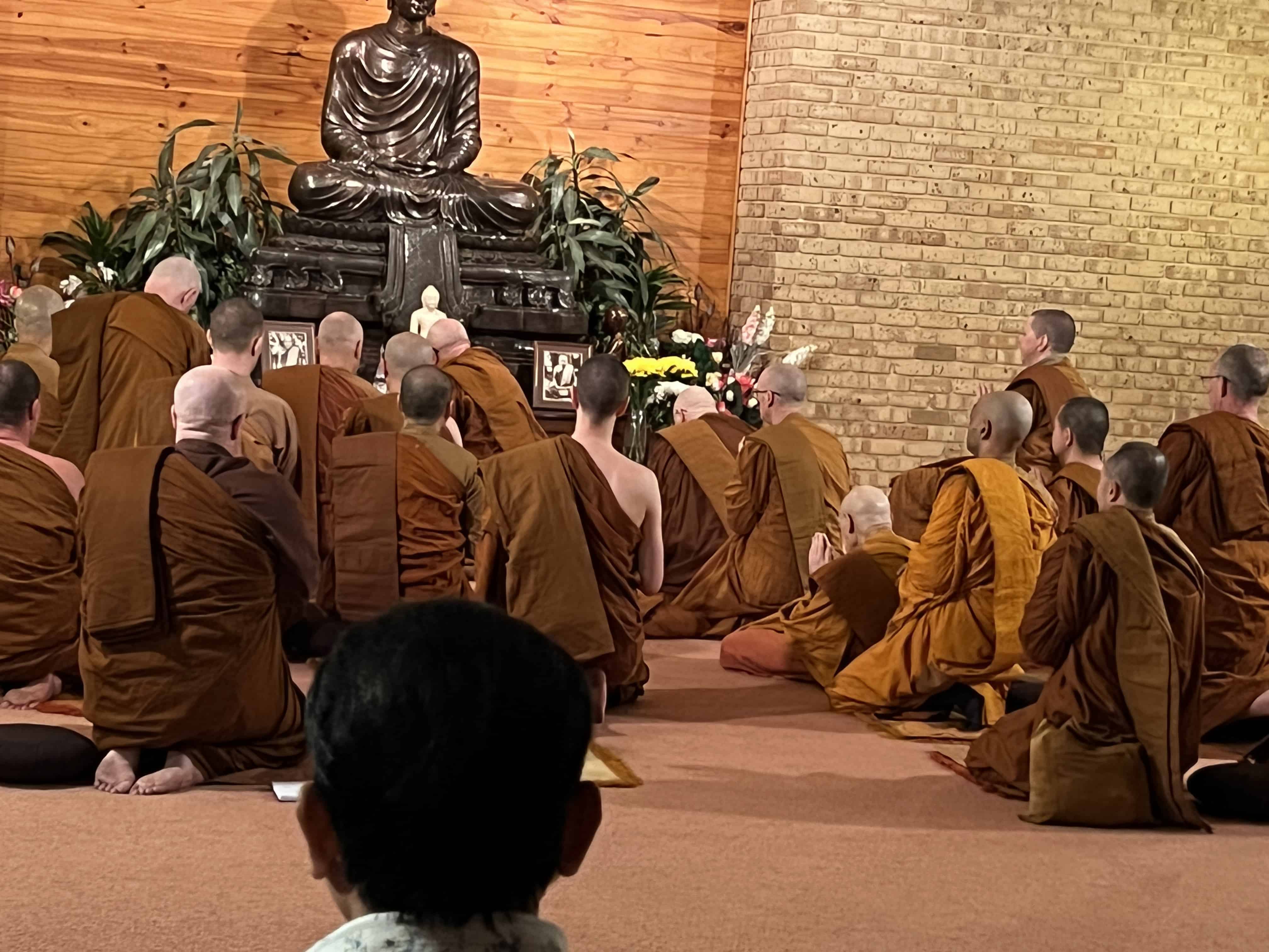 Group of monks bowing to the Buddha